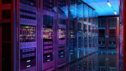A server room featuring multiple servers with purple and blue-ish lights and various wires and buttons. 